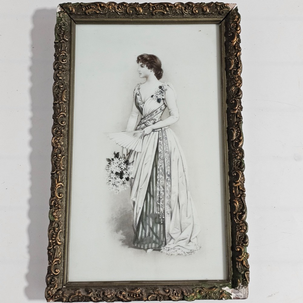 A rectangular framed porcelain plaque featuring a monochrome depiction of an Edwardian lady holding a fan within an ornate gilt frame.
