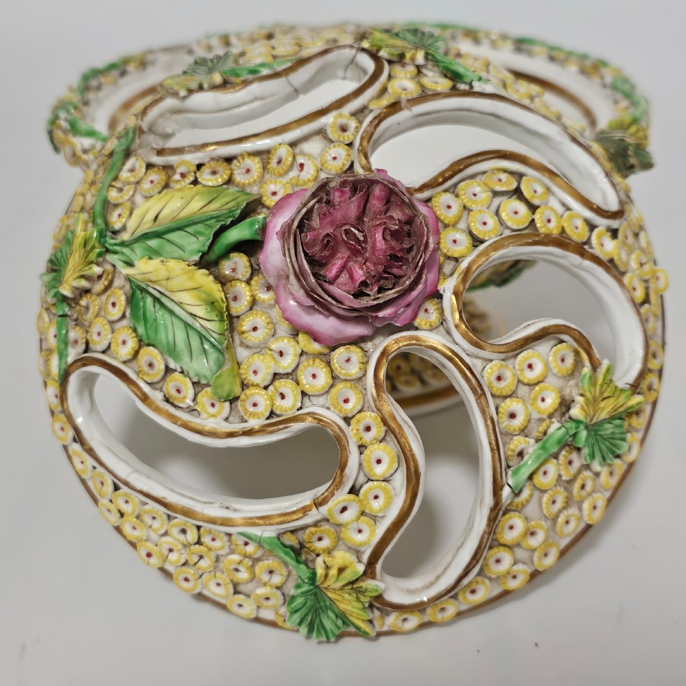 An antique circa 1830 Spode porcelain potpourri bowl with a pierced lid, featuring dense encrusted yellow and green flowers and a central pink rose finial. View II