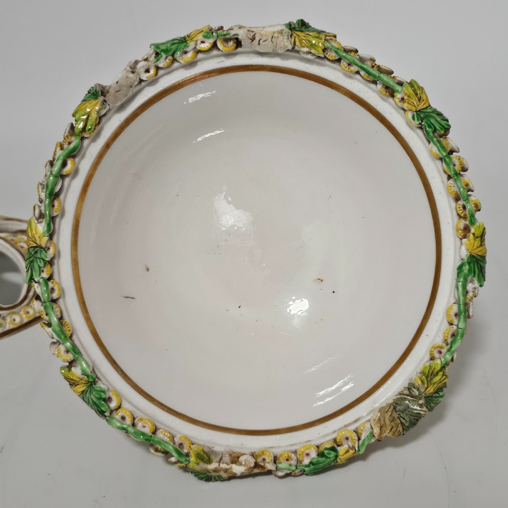 An antique circa 1830 Spode porcelain potpourri bowl with a pierced lid, featuring dense encrusted yellow and green flowers and a central pink rose finial. View V