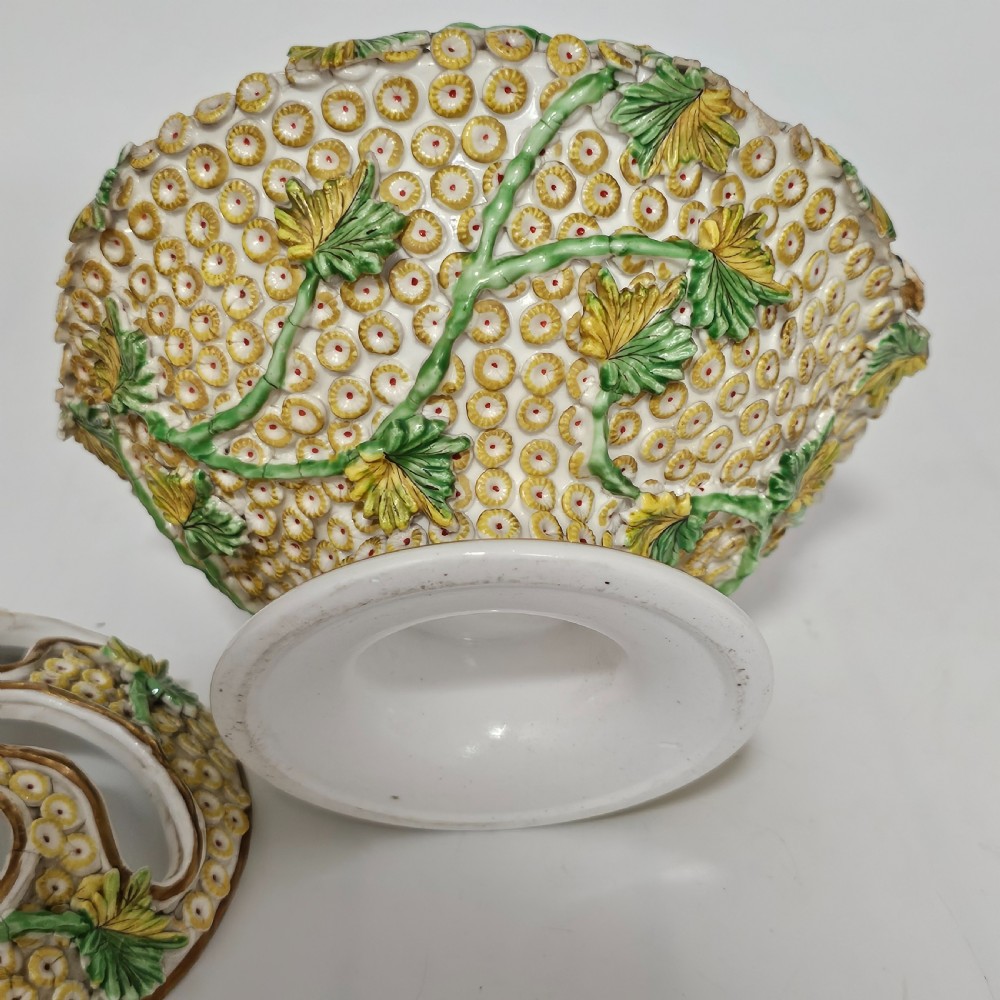 An antique circa 1830 Spode porcelain potpourri bowl with a pierced lid, featuring dense encrusted yellow and green flowers and a central pink rose finial. View VII