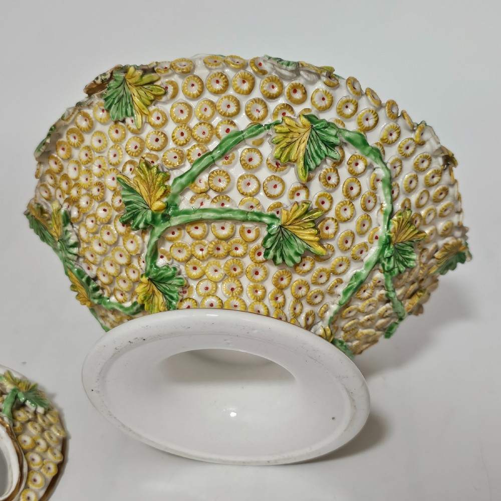 An antique circa 1830 Spode porcelain potpourri bowl with a pierced lid, featuring dense encrusted yellow and green flowers and a central pink rose finial. View VIII