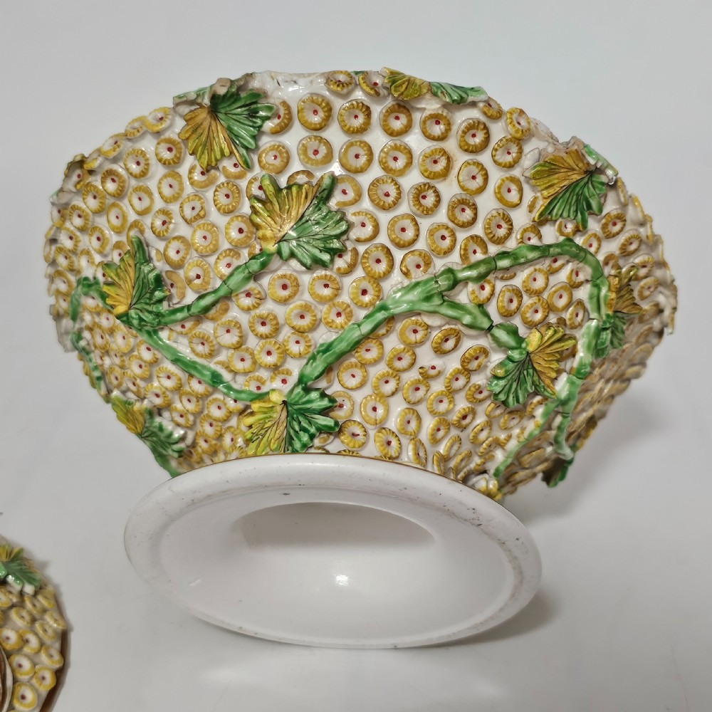 An antique circa 1830 Spode porcelain potpourri bowl with a pierced lid, featuring dense encrusted yellow and green flowers and a central pink rose finial. View IX