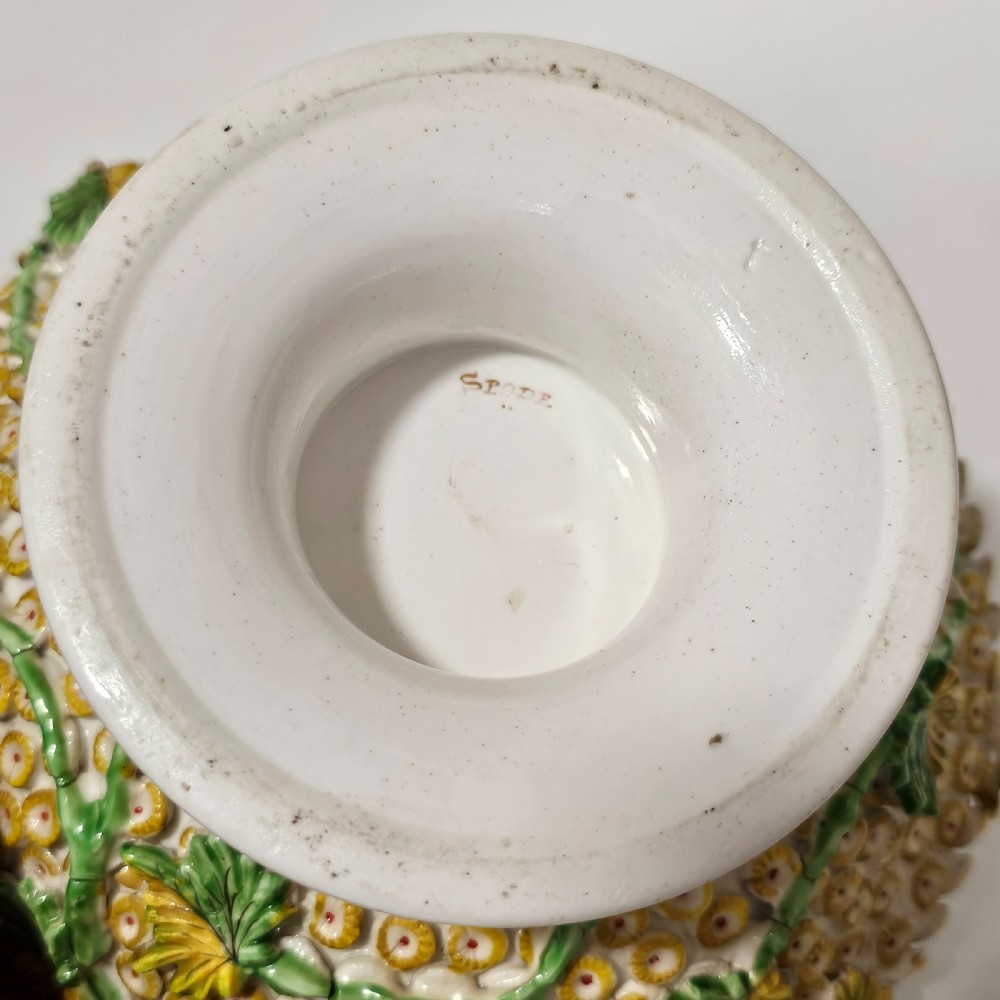 An antique circa 1830 Spode porcelain potpourri bowl with a pierced lid, featuring dense encrusted yellow and green flowers and a central pink rose finial. View X