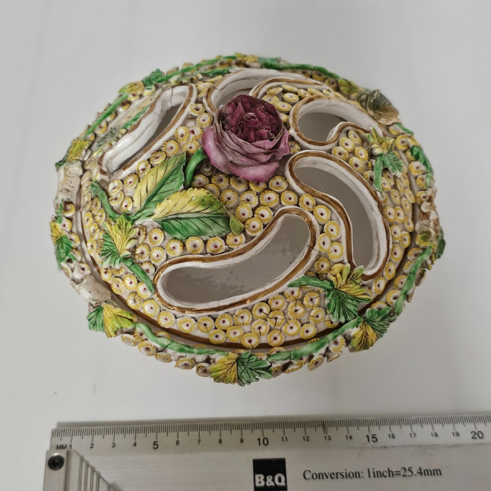 An antique circa 1830 Spode porcelain potpourri bowl with a pierced lid, featuring dense encrusted yellow and green flowers and a central pink rose finial. View XIV