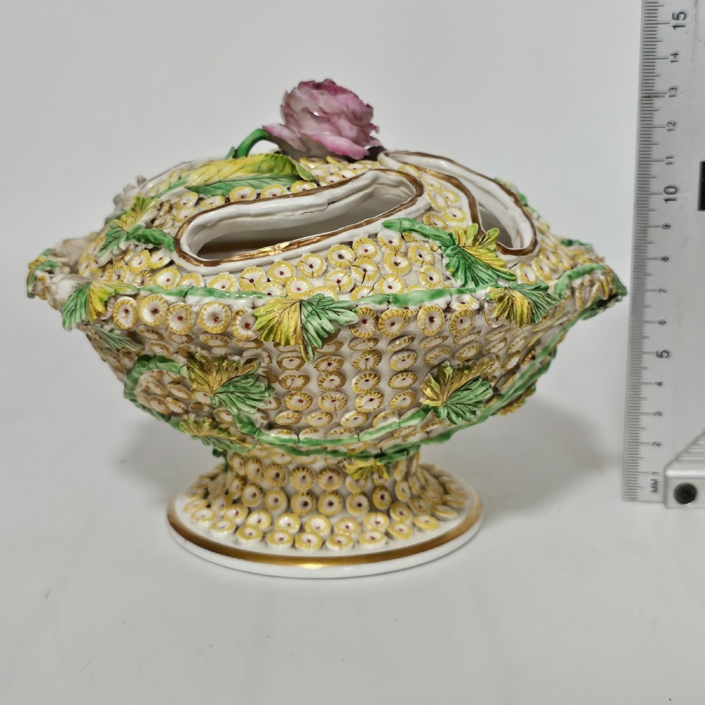 An antique circa 1830 Spode porcelain potpourri bowl with a pierced lid, featuring dense encrusted yellow and green flowers and a central pink rose finial. View XV