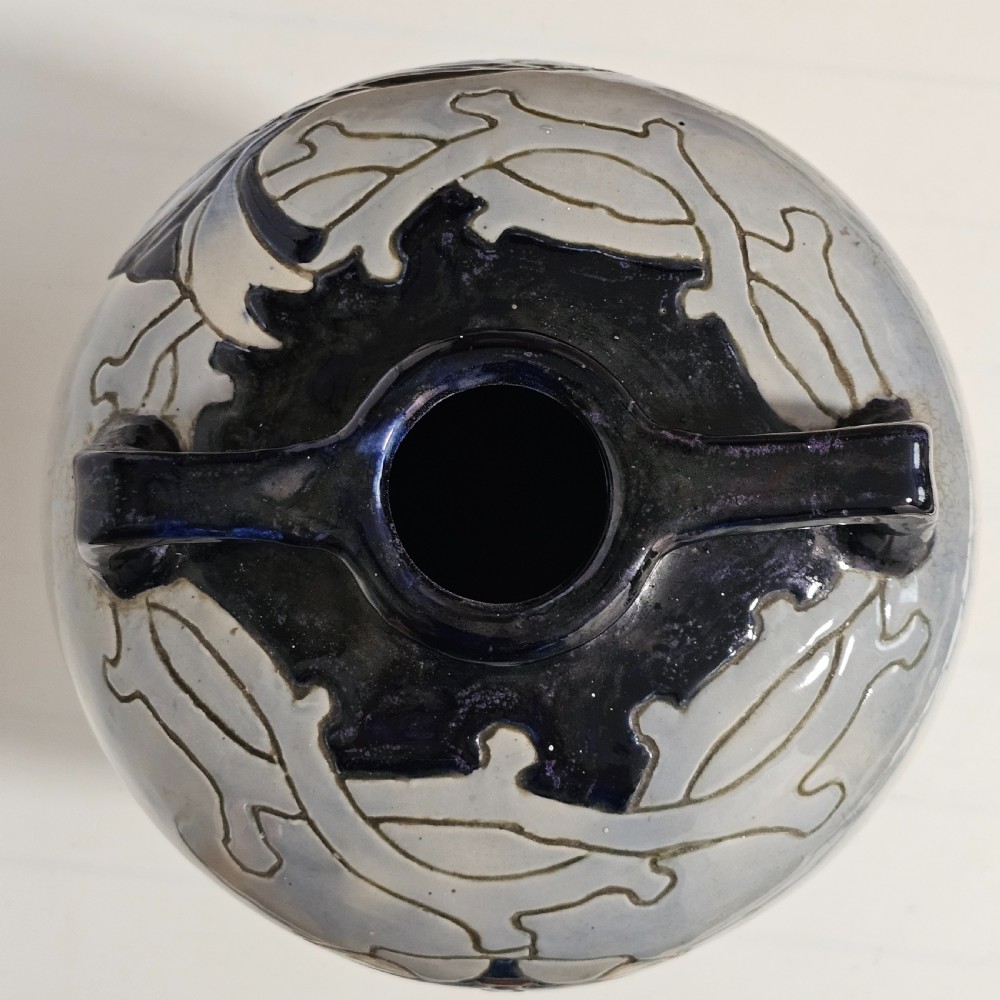 A twin-handled cream ceramic Amphora vase decorated with a stylized bird motif in blue and dark glazes. View V