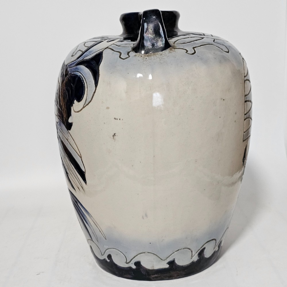 A twin-handled cream ceramic Amphora vase decorated with a stylized bird motif in blue and dark glazes. View IX