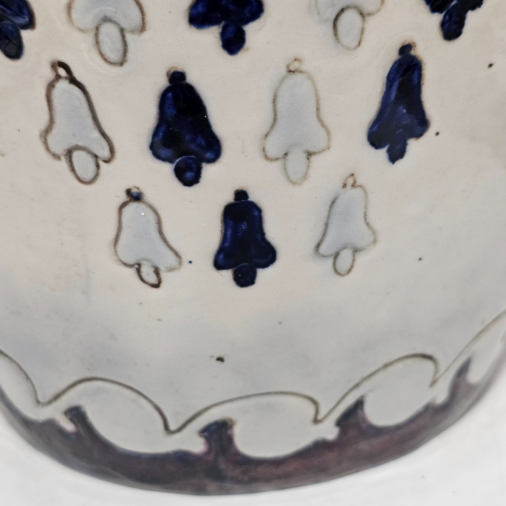 A twin-handled cream ceramic Amphora vase decorated with a stylized bird motif in blue and dark glazes. View XII