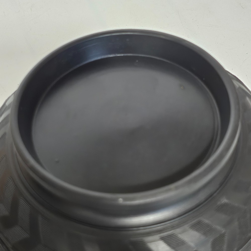 An antique matte black basalt stoneware bowl featuring classical figures in relief around the body and an engine-turned border above the circular foot. View XVI