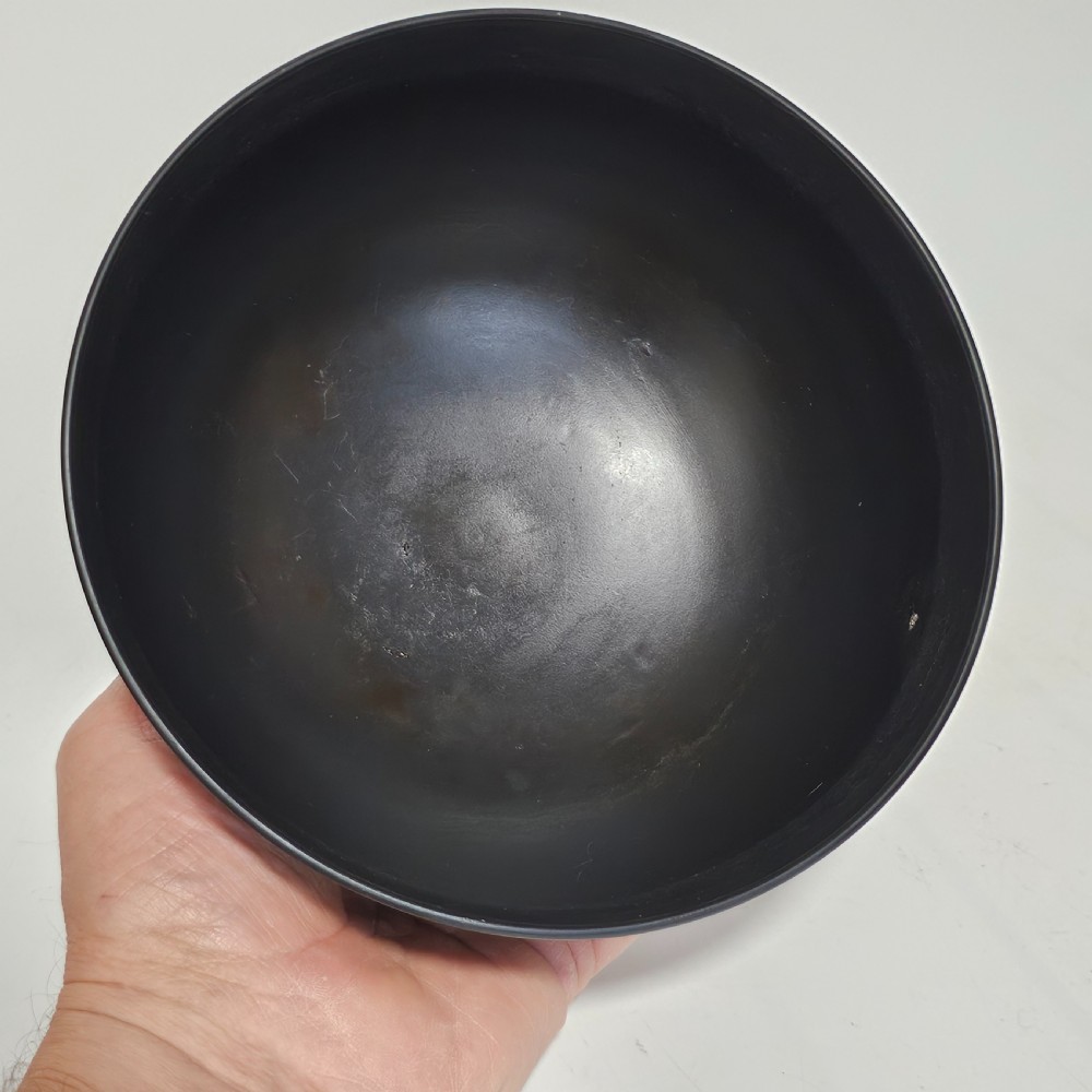An antique matte black basalt stoneware bowl featuring classical figures in relief around the body and an engine-turned border above the circular foot. View XVII