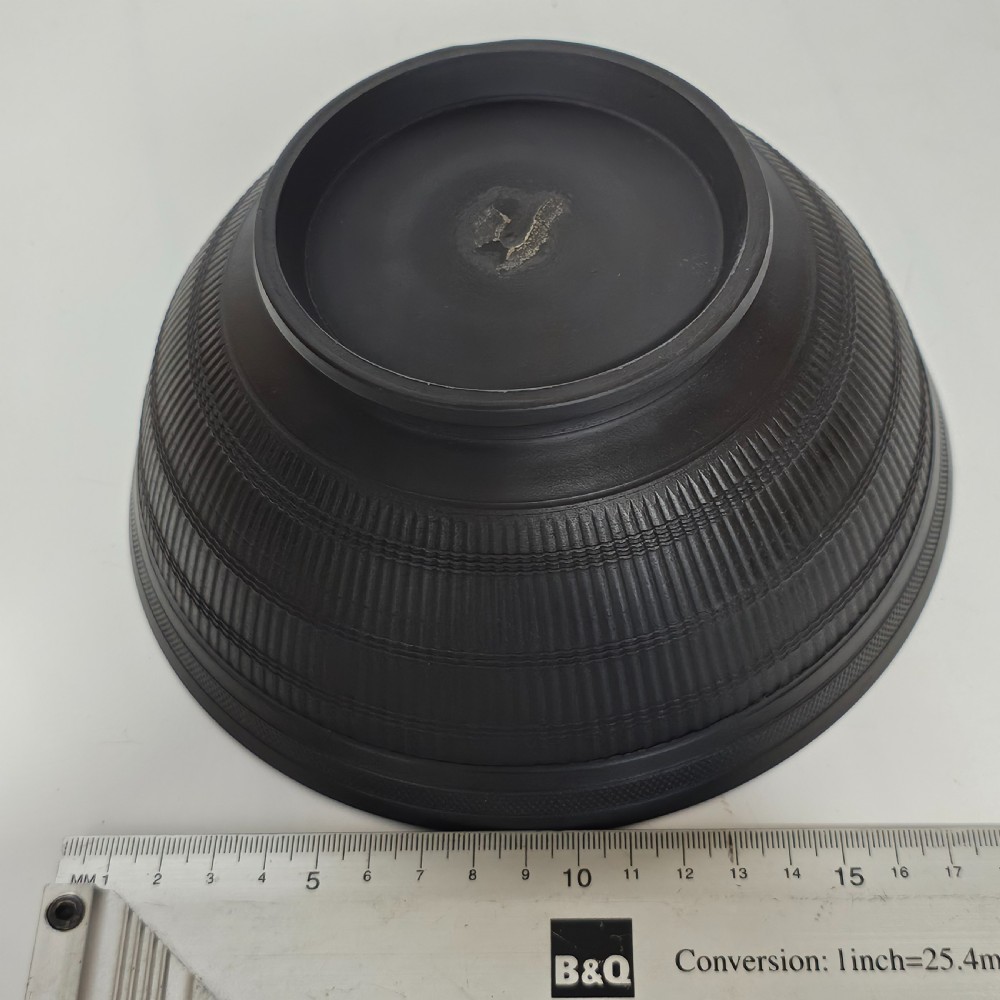 An 18th-century matte black basalt stoneware bowl featuring intricate engine-turned reeded and diced patterns around the exterior. View XII