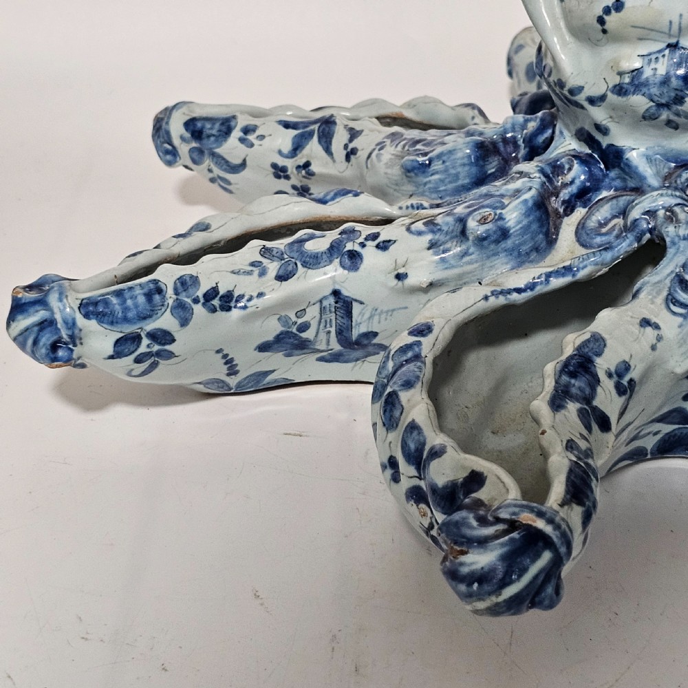 A hand-painted blue and white ceramic starfish dish featuring intricate floral patterns and an elevated central opening. View V