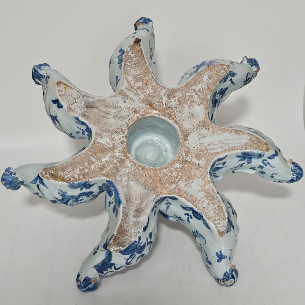 A hand-painted blue and white ceramic starfish dish featuring intricate floral patterns and an elevated central opening. View VI