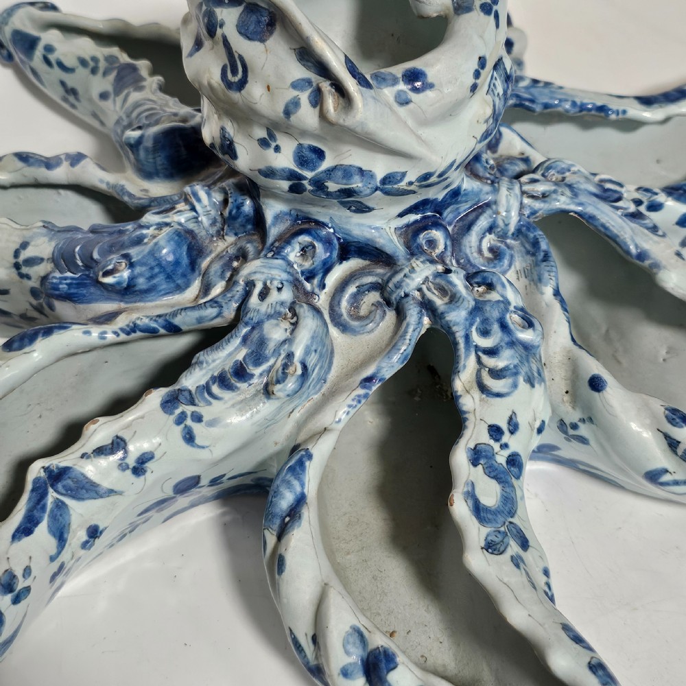 A hand-painted blue and white ceramic starfish dish featuring intricate floral patterns and an elevated central opening. View VIII