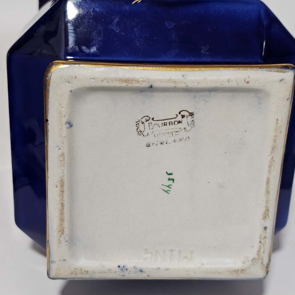 A flared hexagonal cobalt blue porcelain vase decorated with a gilded dragon motif and gold rim. View VI
