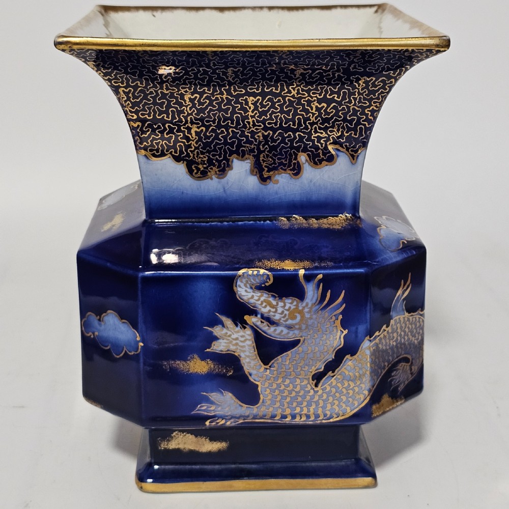 A flared hexagonal cobalt blue porcelain vase decorated with a gilded dragon motif and gold rim. View VIII