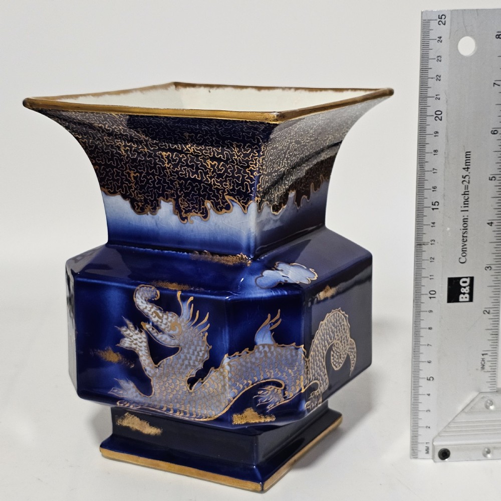 A flared hexagonal cobalt blue porcelain vase decorated with a gilded dragon motif and gold rim. View XI