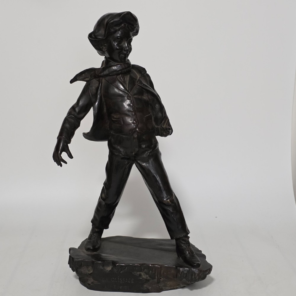 Antoine Bofill (Spanish, 1875-1939), 'La Glissade', 37cm bronze figure of a boy sliding on ice