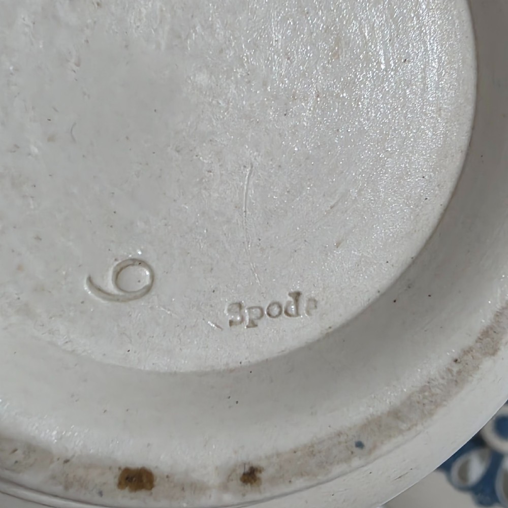 An off-white Georgian stoneware pot pourri basket featuring an overhead handle, pierced cover, and cobalt blue applied grapevine sprig decoration. View XII