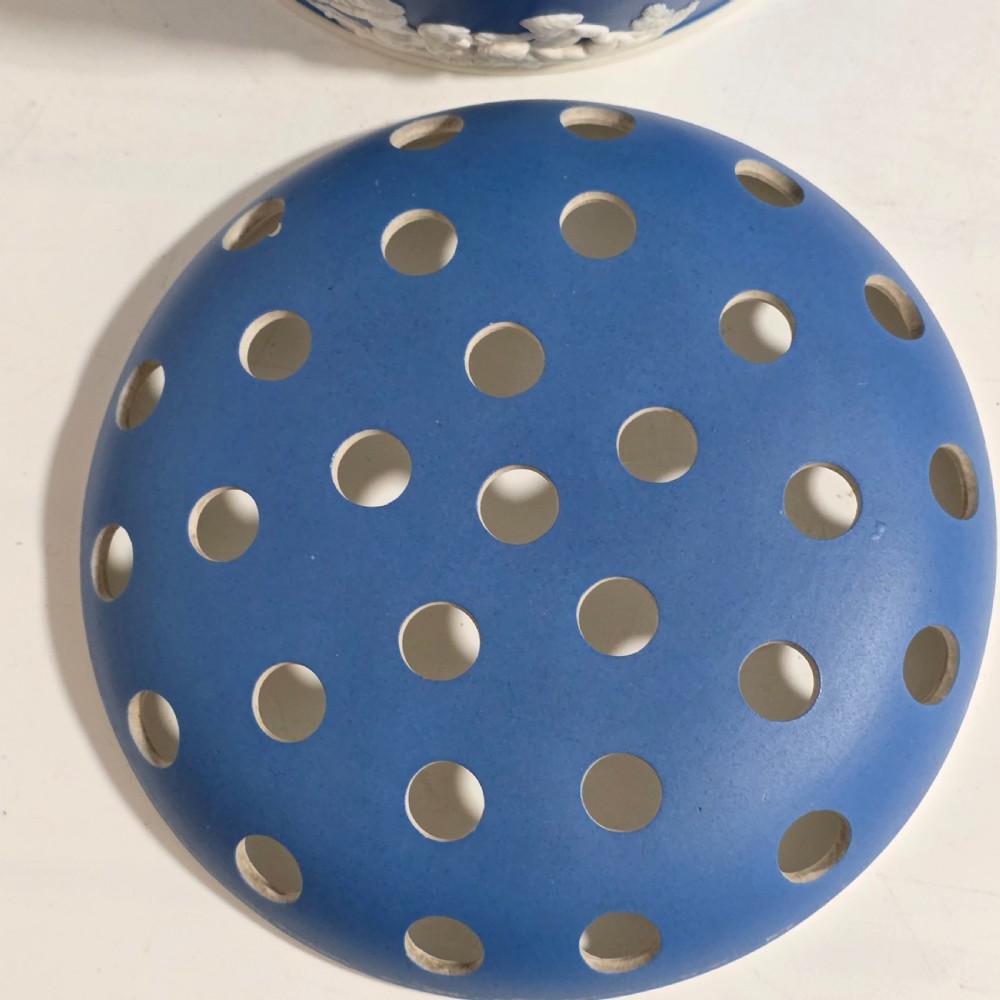 A pair of blue and white Georgian ceramic pot pourri baskets with pierced lids, white classical cherub reliefs, and overhead handles. View XVII