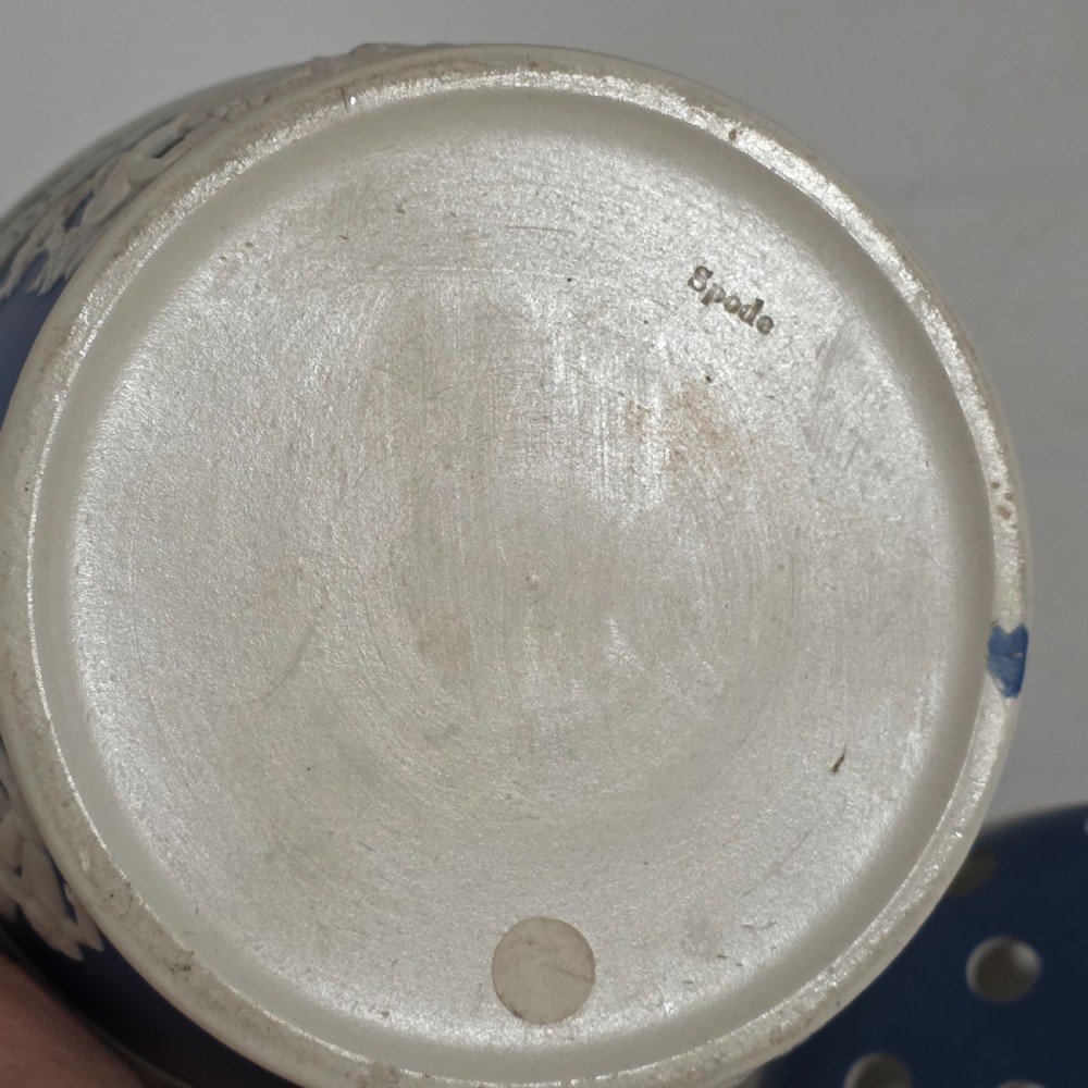 A pair of blue and white Georgian ceramic pot pourri baskets with pierced lids, white classical cherub reliefs, and overhead handles. View XXIII