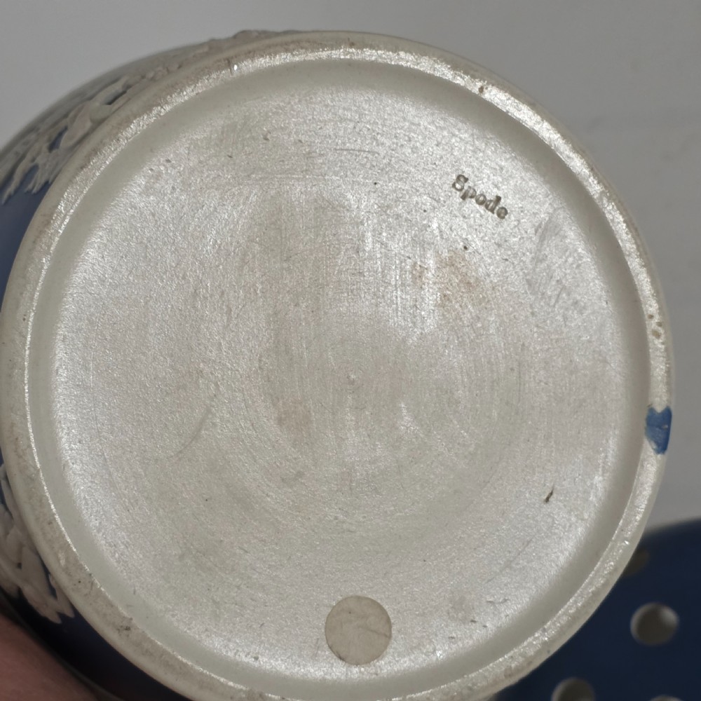 A pair of blue and white Georgian ceramic pot pourri baskets with pierced lids, white classical cherub reliefs, and overhead handles. View XXIV
