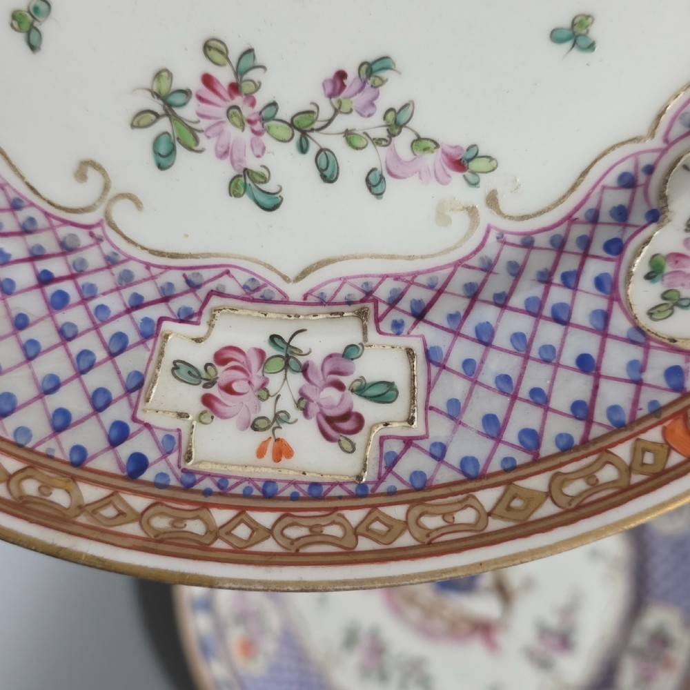 A pair of nineteenth-century Samson porcelain cabinet plates featuring hand-painted coat of arms crests surrounded by floral sprays and purple lattice borders. View VIII