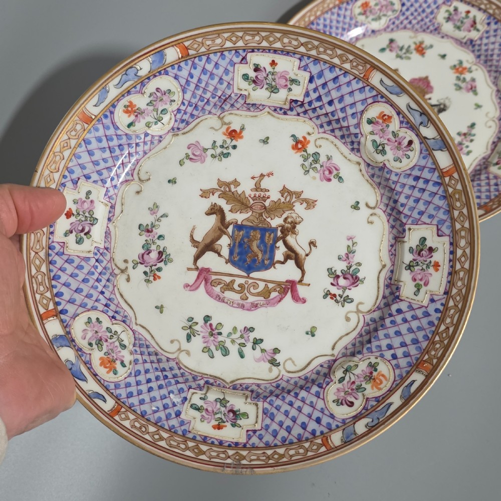 A pair of nineteenth-century Samson porcelain cabinet plates featuring hand-painted coat of arms crests surrounded by floral sprays and purple lattice borders. View X