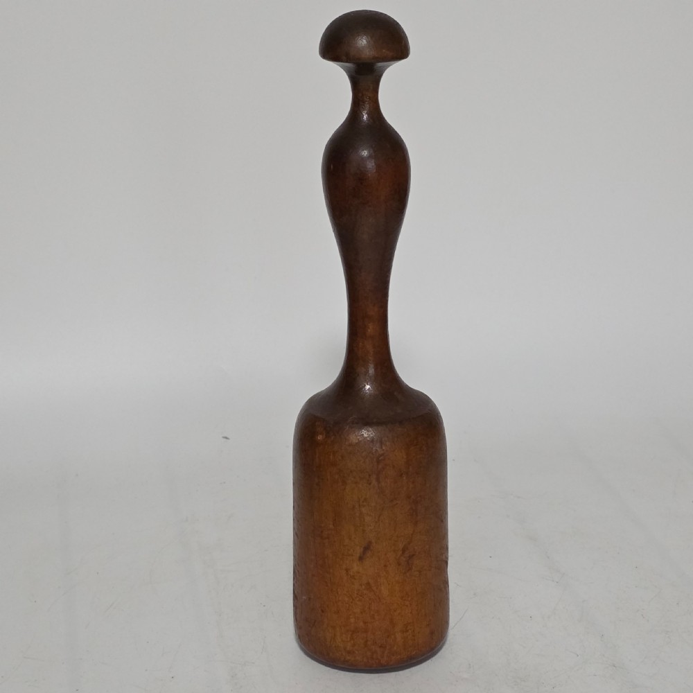 A 19th-century hand-turned sycamore wood potato masher featuring a domed cap top, slender baluster handle, and smooth cylindrical base.