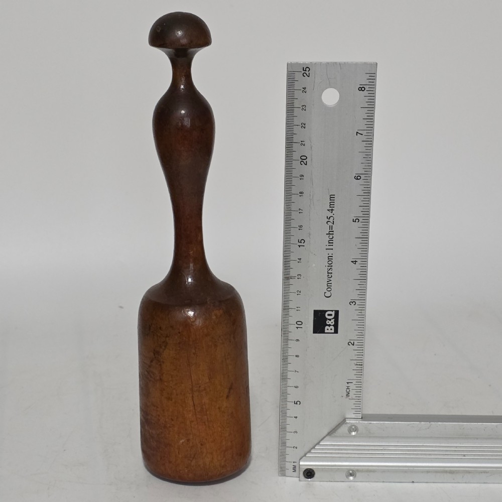 A 19th-century hand-turned sycamore wood potato masher featuring a domed cap top, slender baluster handle, and smooth cylindrical base. View II