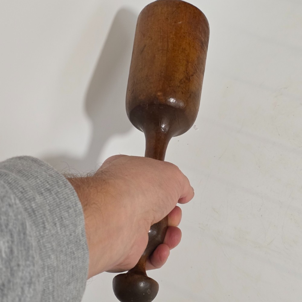 A 19th-century hand-turned sycamore wood potato masher featuring a domed cap top, slender baluster handle, and smooth cylindrical base. View III
