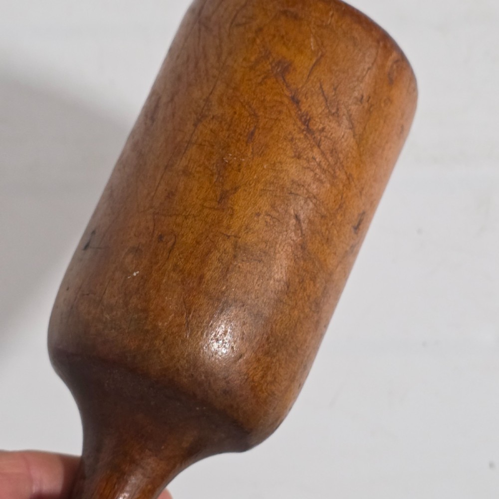 A 19th-century hand-turned sycamore wood potato masher featuring a domed cap top, slender baluster handle, and smooth cylindrical base. View VI