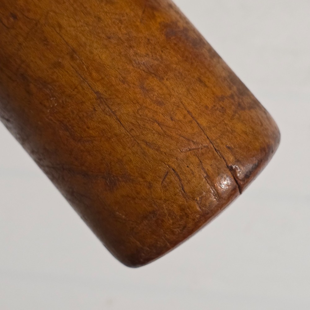 A 19th-century hand-turned sycamore wood potato masher featuring a domed cap top, slender baluster handle, and smooth cylindrical base. View VII