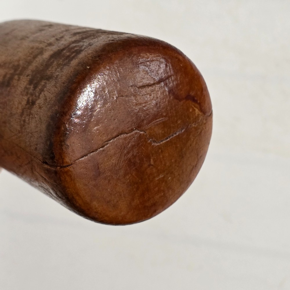 A 19th-century hand-turned sycamore wood potato masher featuring a domed cap top, slender baluster handle, and smooth cylindrical base. View VIII