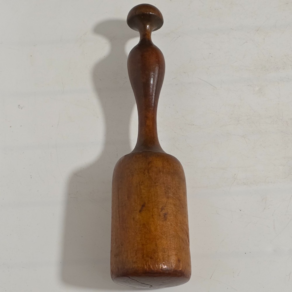 A 19th-century hand-turned sycamore wood potato masher featuring a domed cap top, slender baluster handle, and smooth cylindrical base. View IX