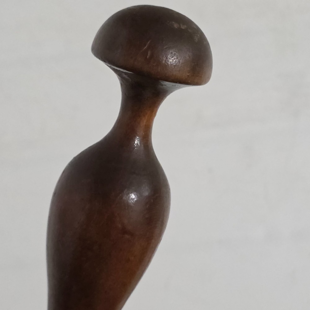 A 19th-century hand-turned sycamore wood potato masher featuring a domed cap top, slender baluster handle, and smooth cylindrical base. View X