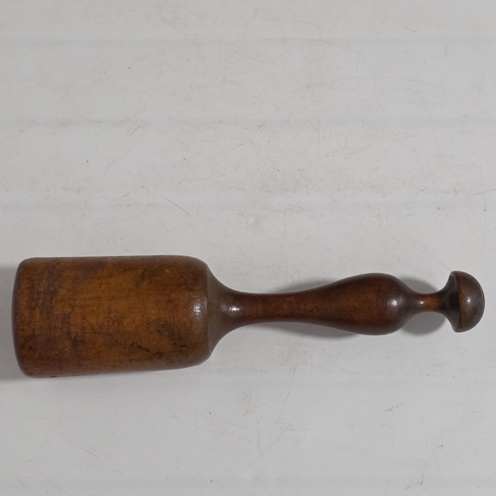 A 19th-century hand-turned sycamore wood potato masher featuring a domed cap top, slender baluster handle, and smooth cylindrical base. View XI
