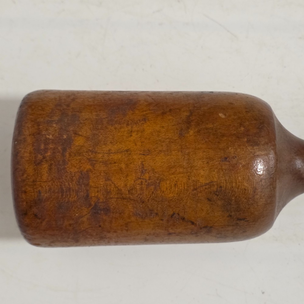 A 19th-century hand-turned sycamore wood potato masher featuring a domed cap top, slender baluster handle, and smooth cylindrical base. View XII