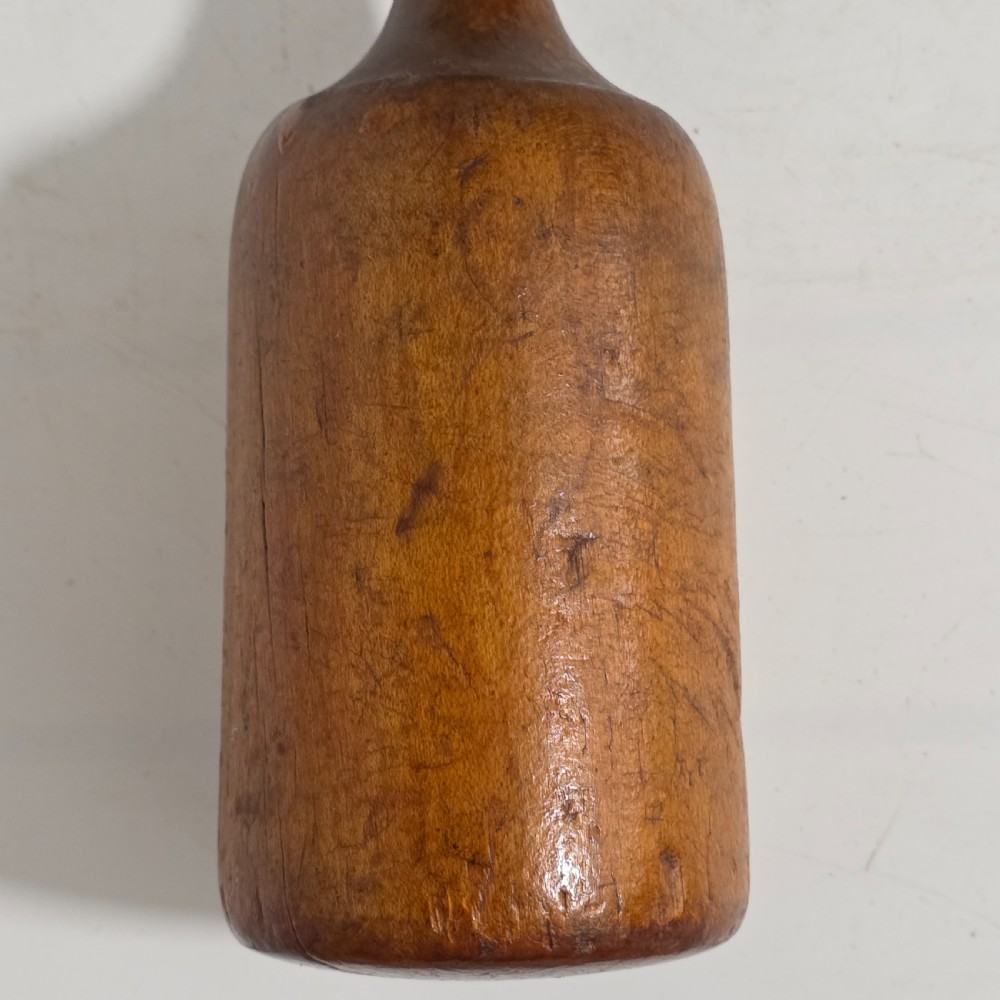 A 19th-century hand-turned sycamore wood potato masher featuring a domed cap top, slender baluster handle, and smooth cylindrical base. View XIII