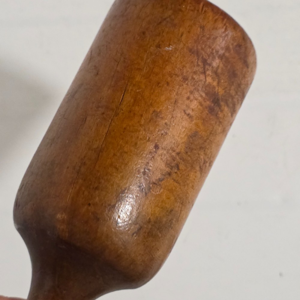 A 19th-century hand-turned sycamore wood potato masher featuring a domed cap top, slender baluster handle, and smooth cylindrical base. View XV