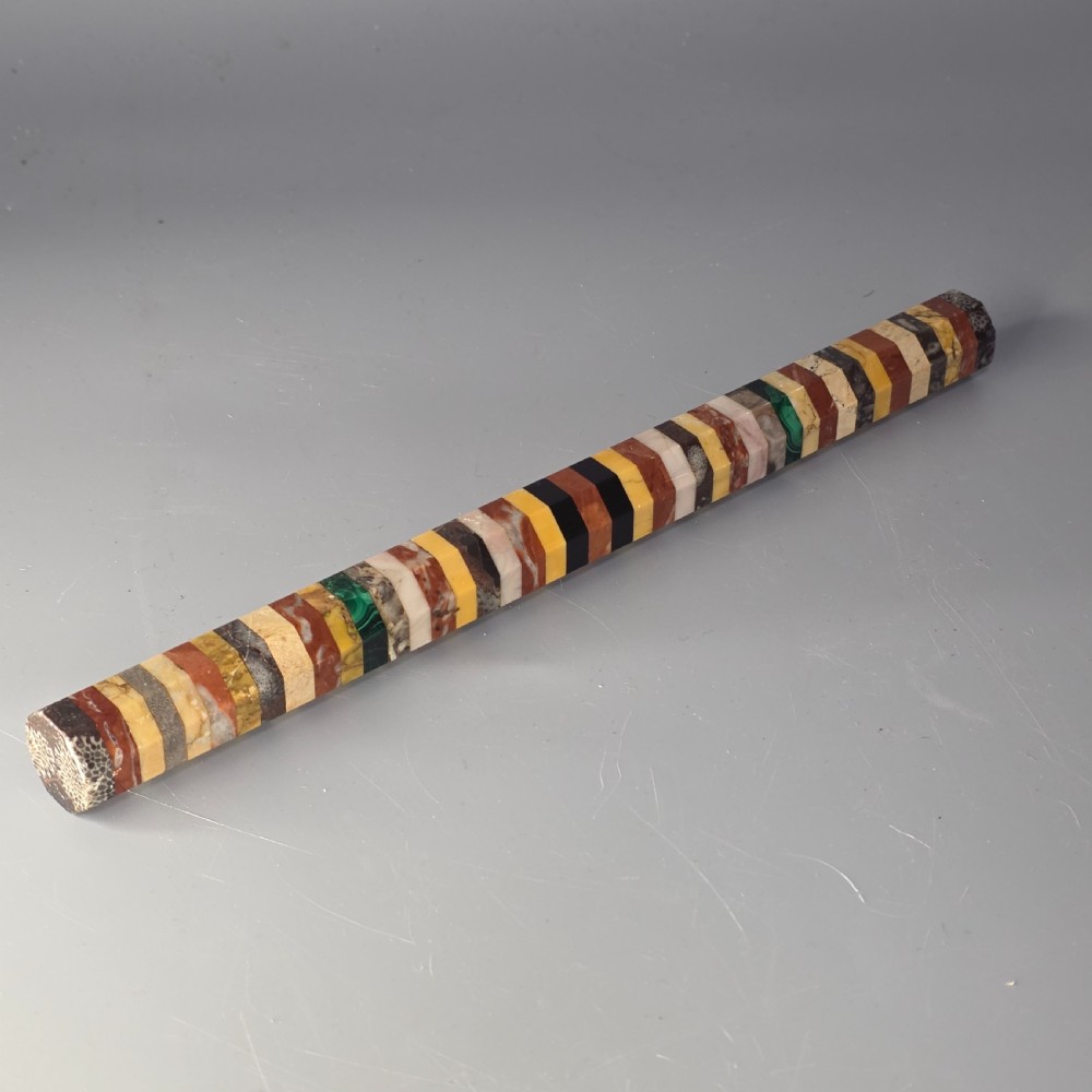 An antique octagonal ruler constructed from alternating segments of multi-coloured specimen marbles, agate, and malachite.