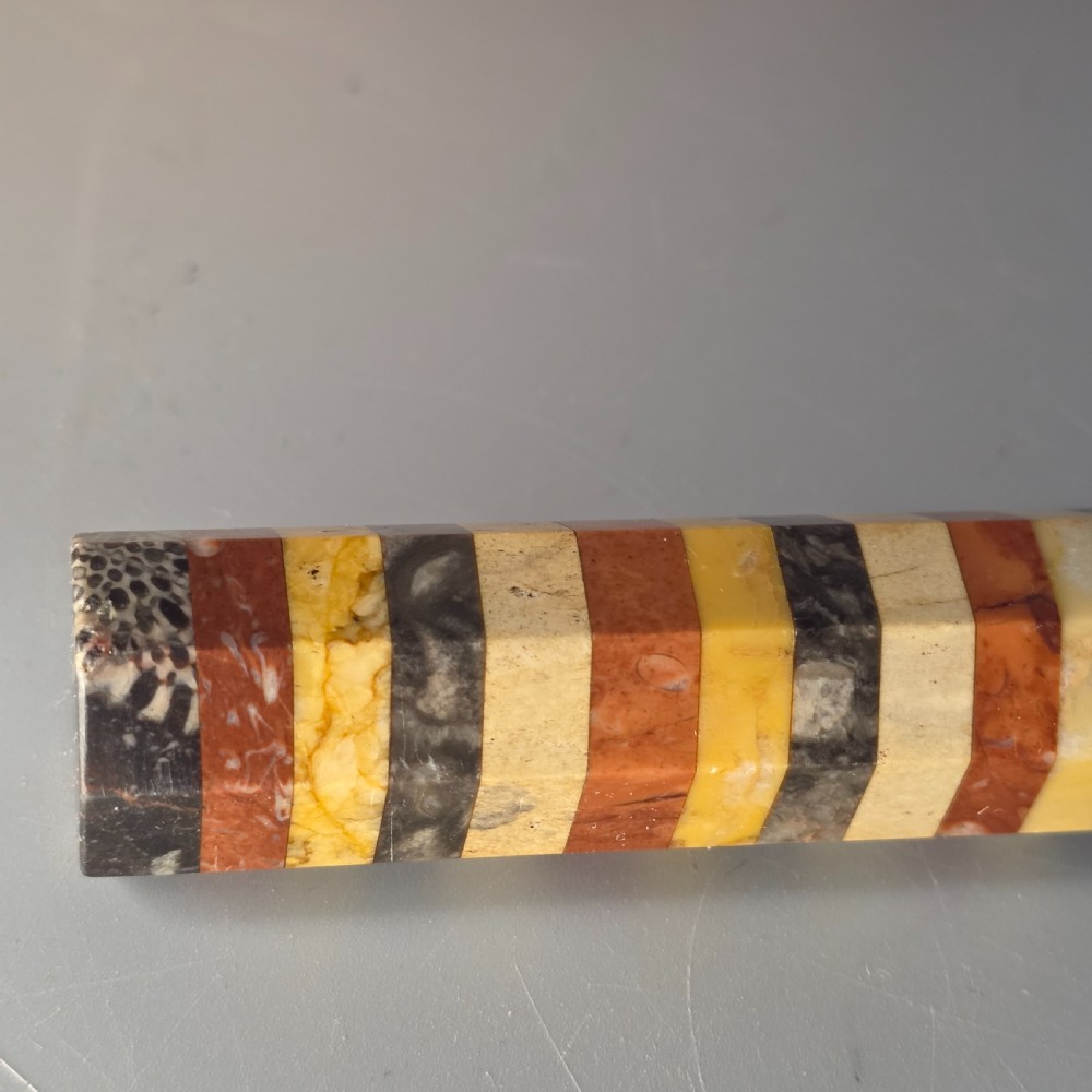 An antique octagonal ruler constructed from alternating segments of multi-coloured specimen marbles, agate, and malachite. View XVIII