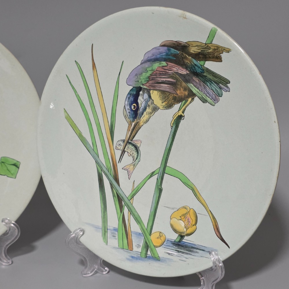 A pair of circular pale green ceramic display plates hand painted with detailed birds near water lilies and reeds. View V