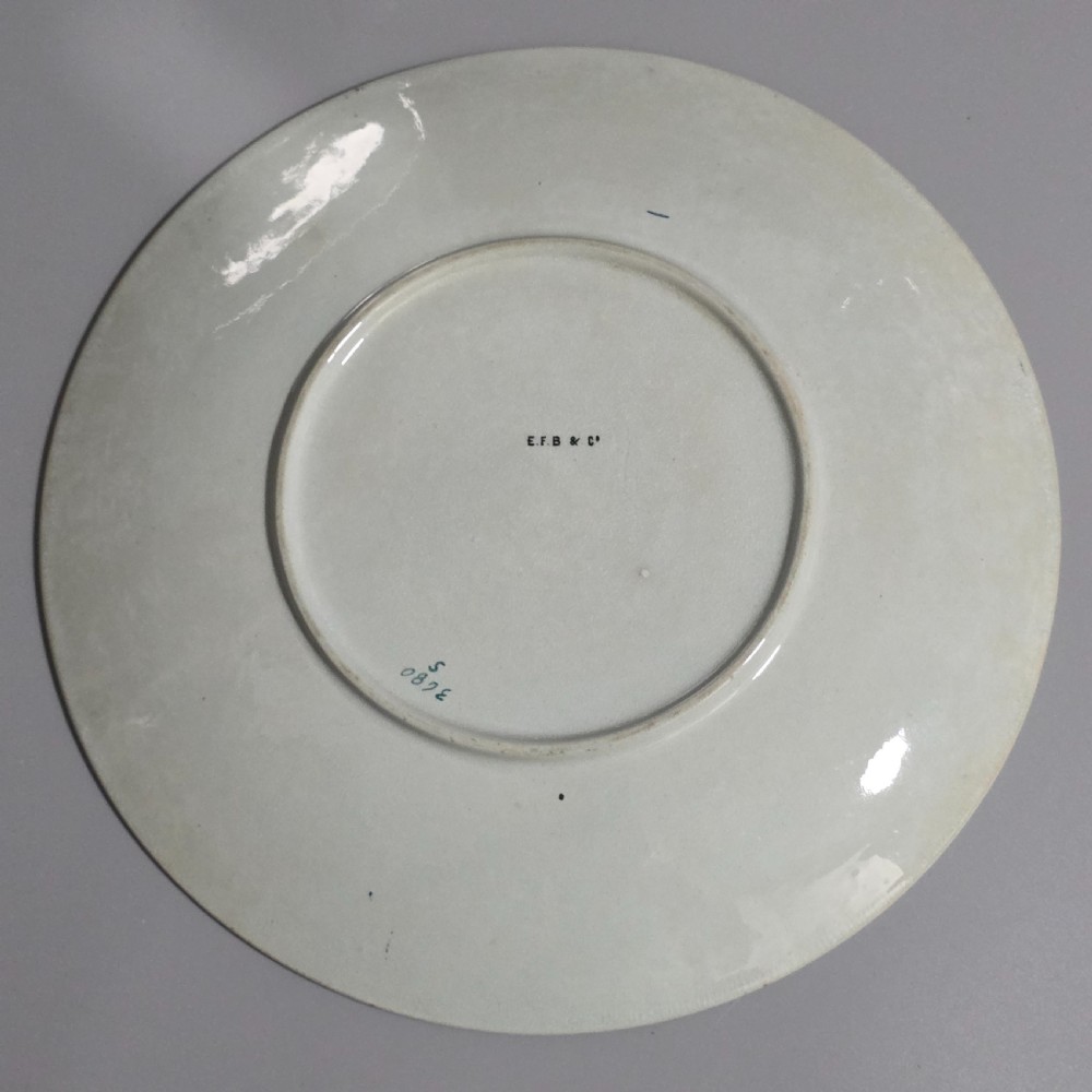 A pair of circular pale green ceramic display plates hand painted with detailed birds near water lilies and reeds. View VII