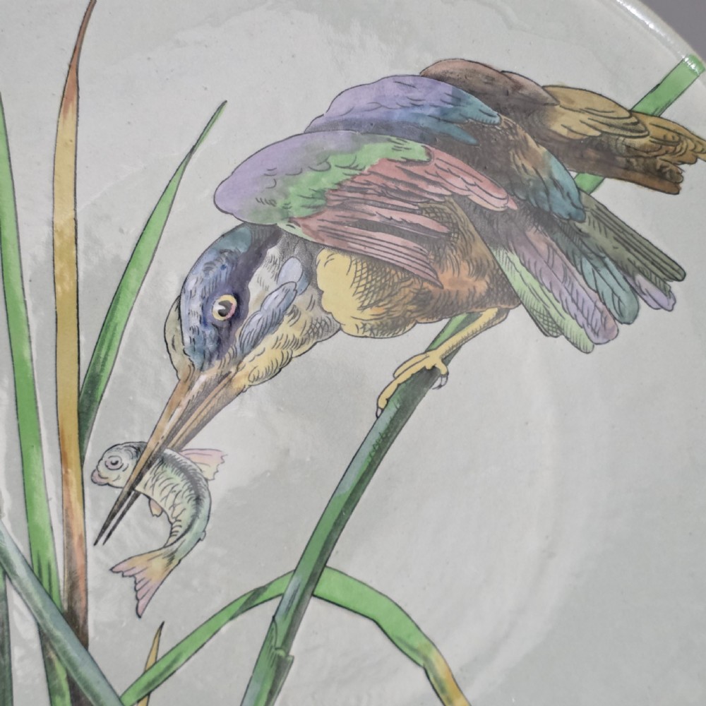 A pair of circular pale green ceramic display plates hand painted with detailed birds near water lilies and reeds. View VIII