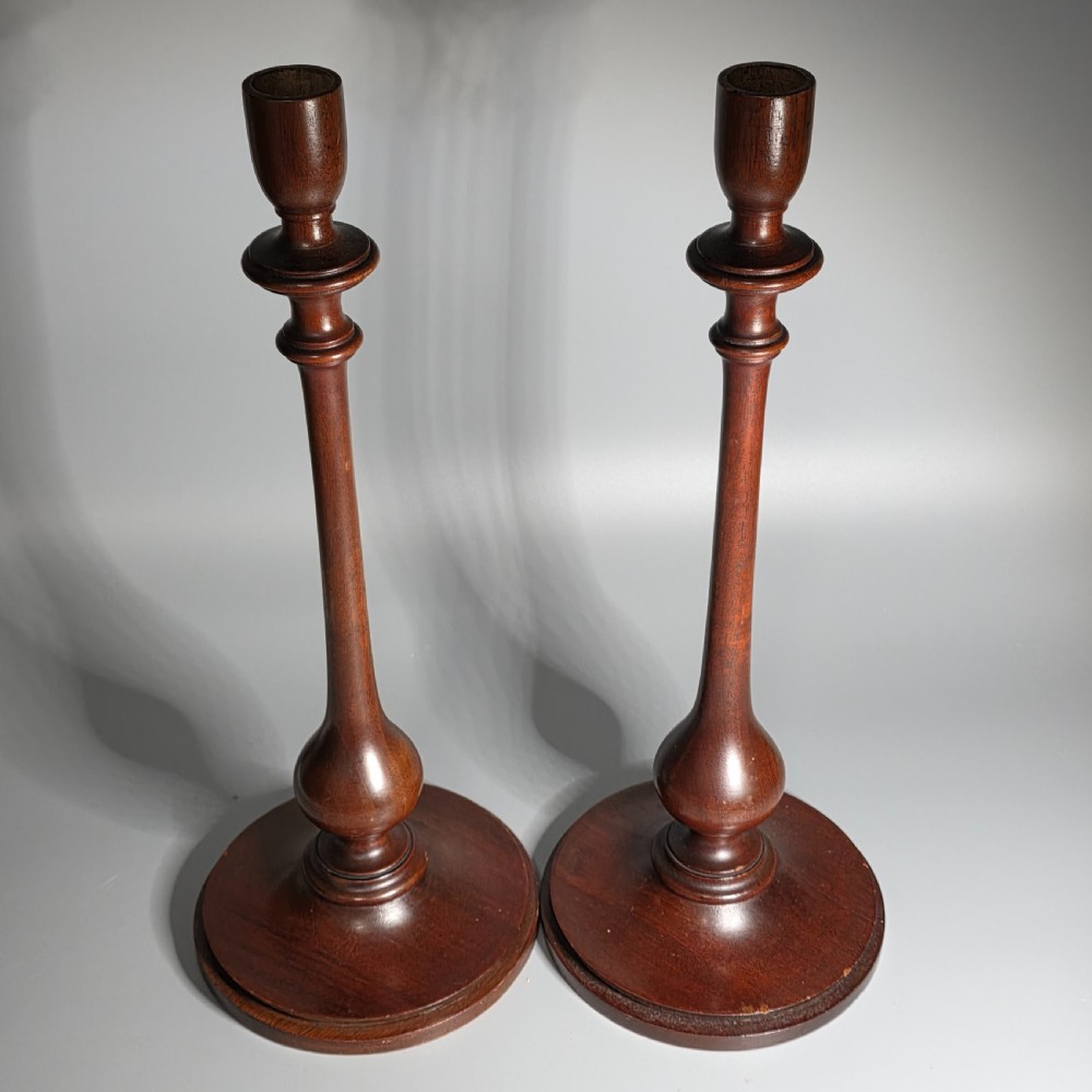 A pair of tall turned dark wood candlesticks featuring bulbous lower shafts and circular stepped bases. View IV