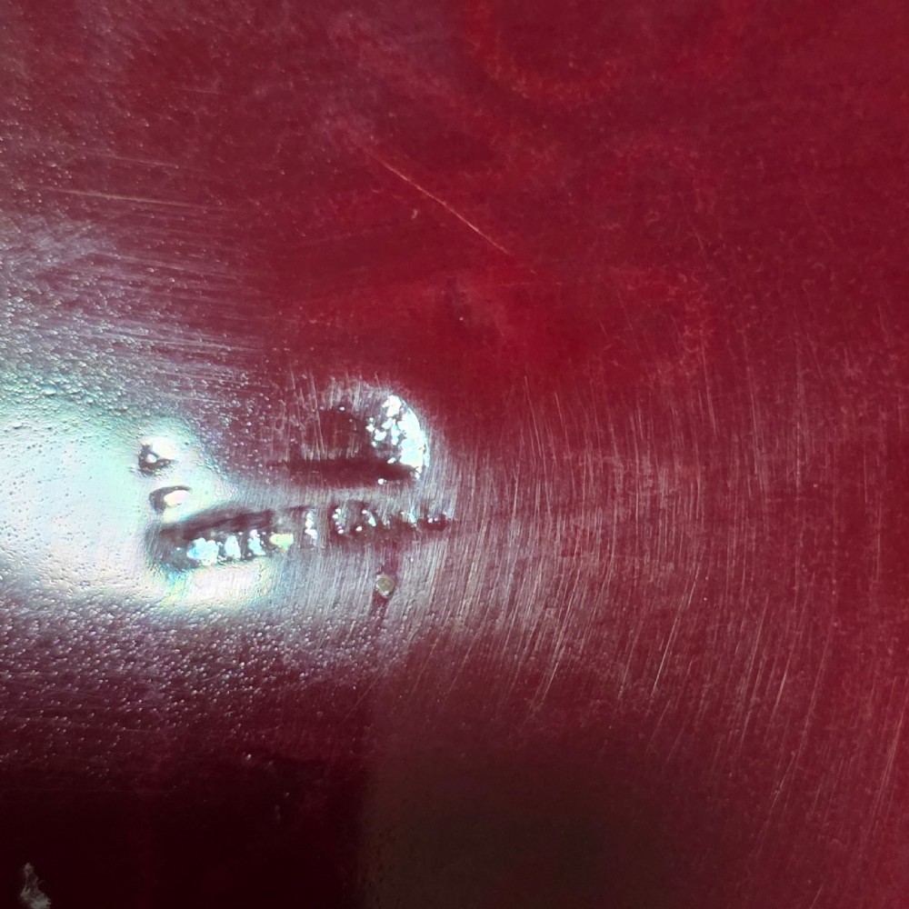 A shallow ceramic art pottery plate featuring a crimson red flambe glaze combined with golden-brown crystalline textures and a scalloped edge. View VII
