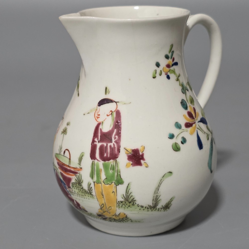 An 18th-century Worcester porcelain sparrow beak cream jug of baluster form, hand-painted with polychrome enamel figures and foliage.
