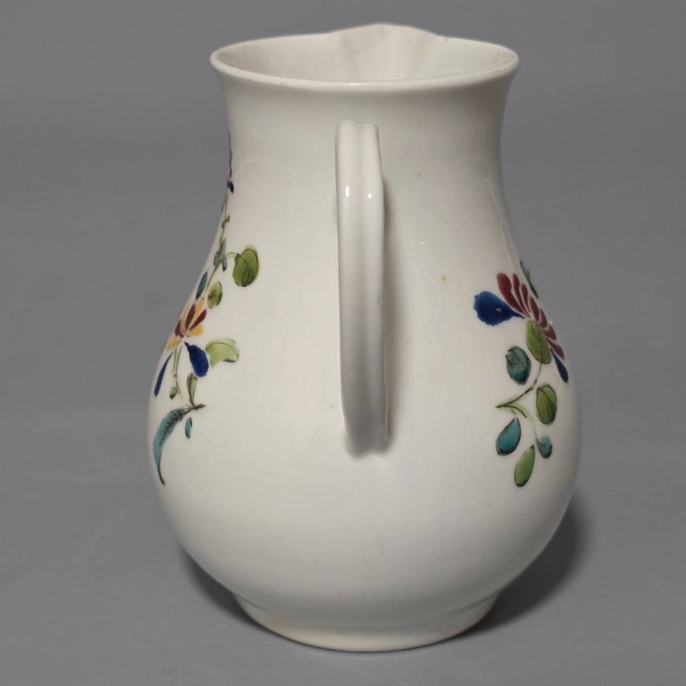 An 18th-century Worcester porcelain sparrow beak cream jug of baluster form, hand-painted with polychrome enamel figures and foliage. View III
