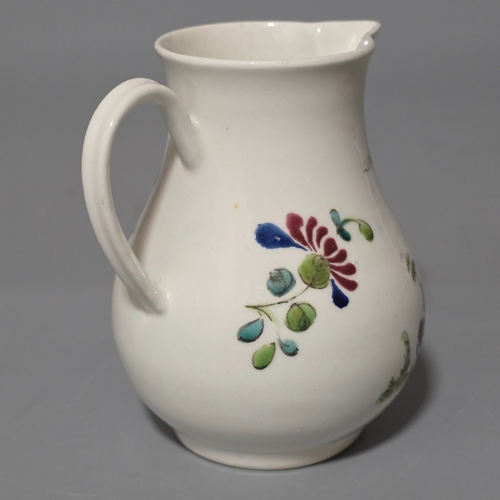 An 18th-century Worcester porcelain sparrow beak cream jug of baluster form, hand-painted with polychrome enamel figures and foliage. View IV